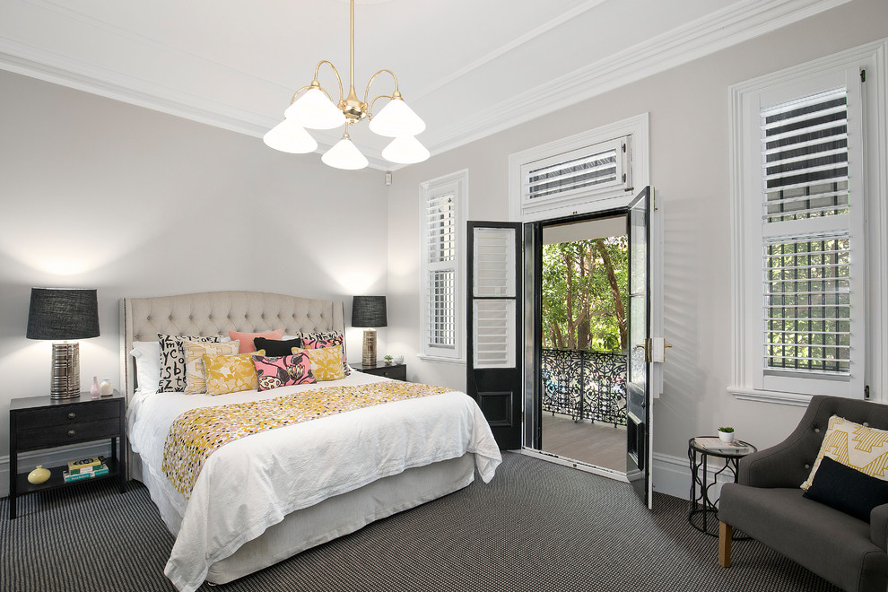 Design ideas for a mid-sized transitional master bedroom in Newcastle - Maitland with beige walls, carpet, black floor and no fireplace.