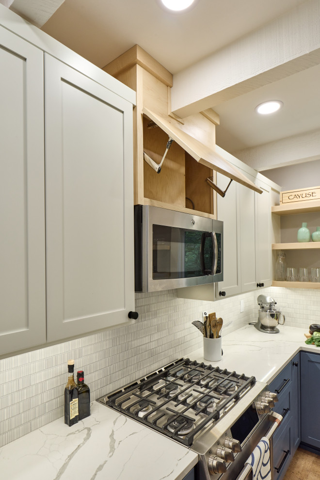 This is an example of an eat-in kitchen in Other with a single-bowl sink, shaker cabinets, blue cabinets, quartz benchtops, grey splashback, ceramic splashback, stainless steel appliances, cork floors, with island, beige floor, white benchtop and exposed beam.