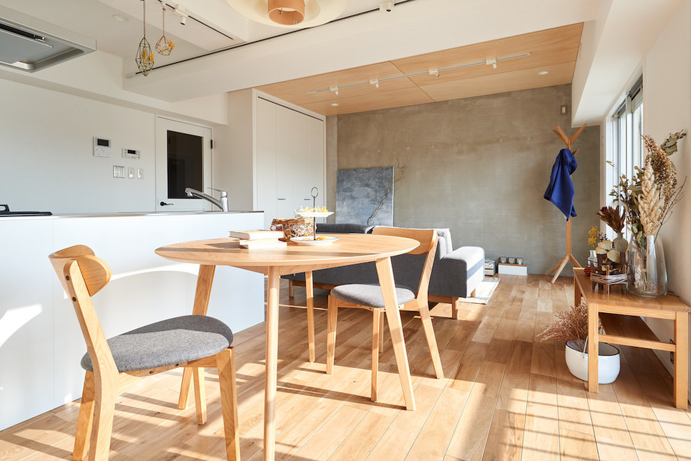 Photo of a scandinavian open plan dining in Other with grey walls, medium hardwood floors and beige floor.