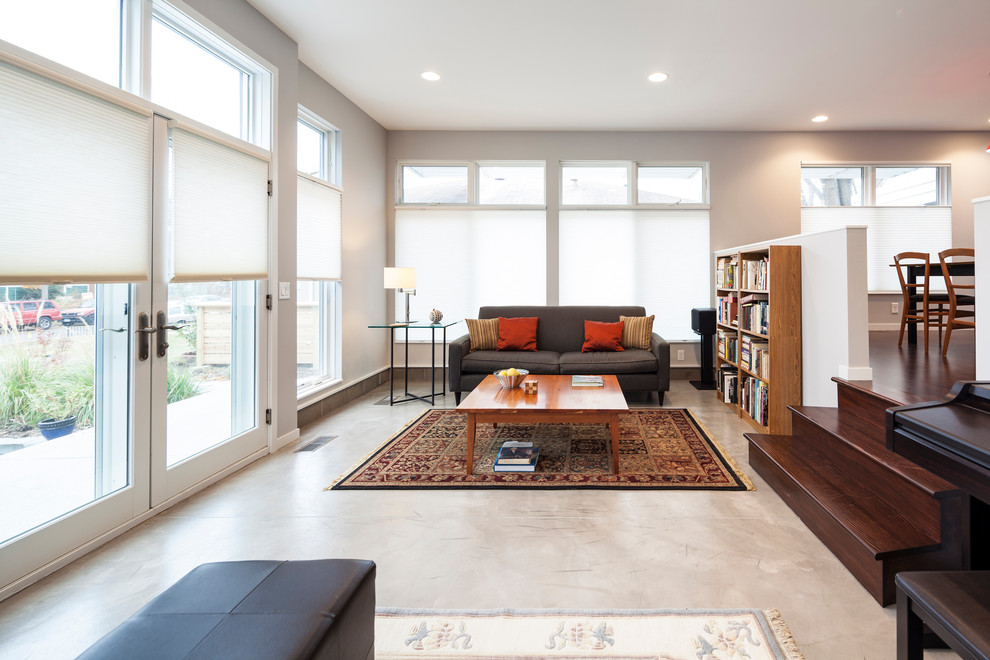 Photo of a mid-sized contemporary open concept living room in Minneapolis with grey walls and concrete floors.