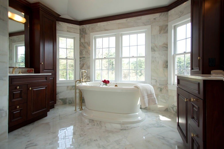 Large transitional master white tile and stone tile marble floor freestanding bathtub photo in Boston with dark wood cabinets