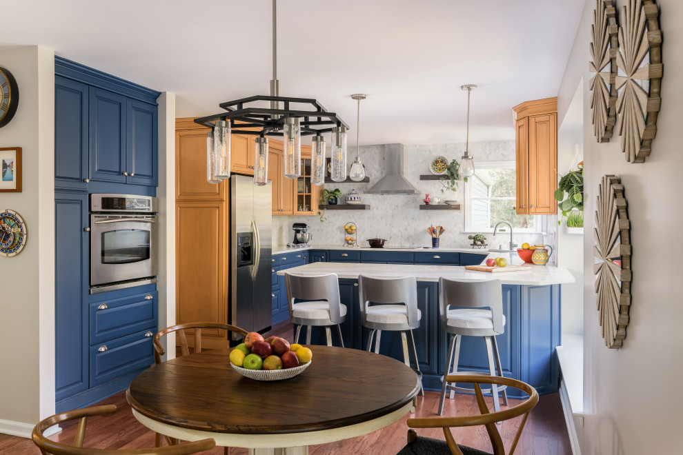 Photo of a mid-sized traditional u-shaped kitchen in Philadelphia with raised-panel cabinets, blue cabinets, quartz benchtops, white splashback, marble splashback and white benchtop.