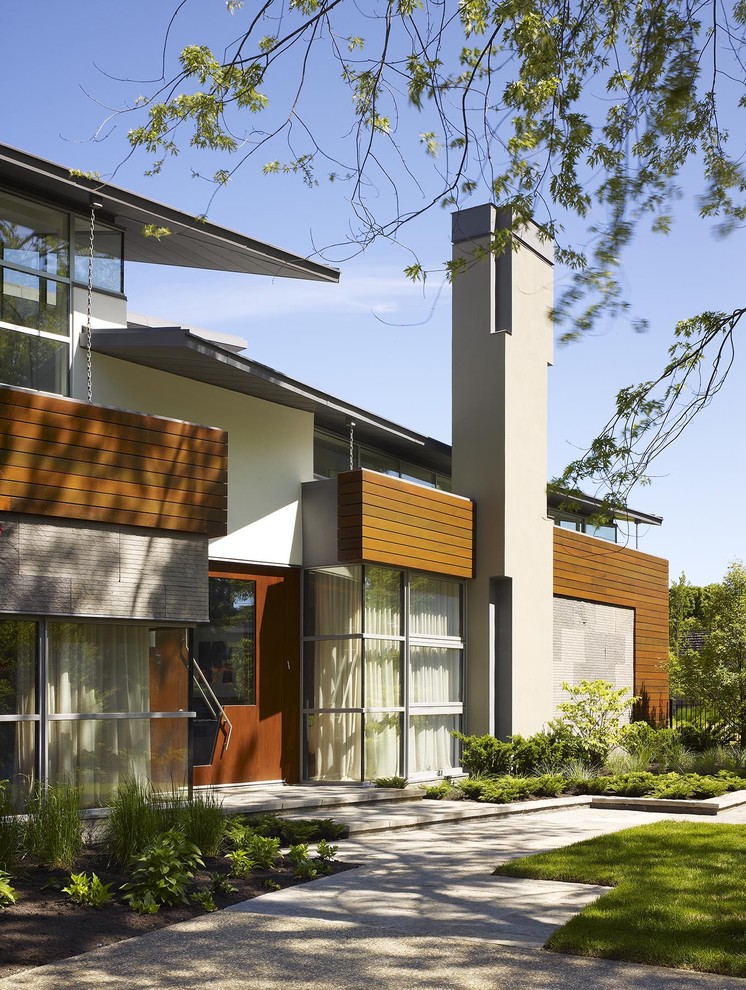 Inspiration for an expansive midcentury two-storey red exterior in Toronto with wood siding and a shed roof.