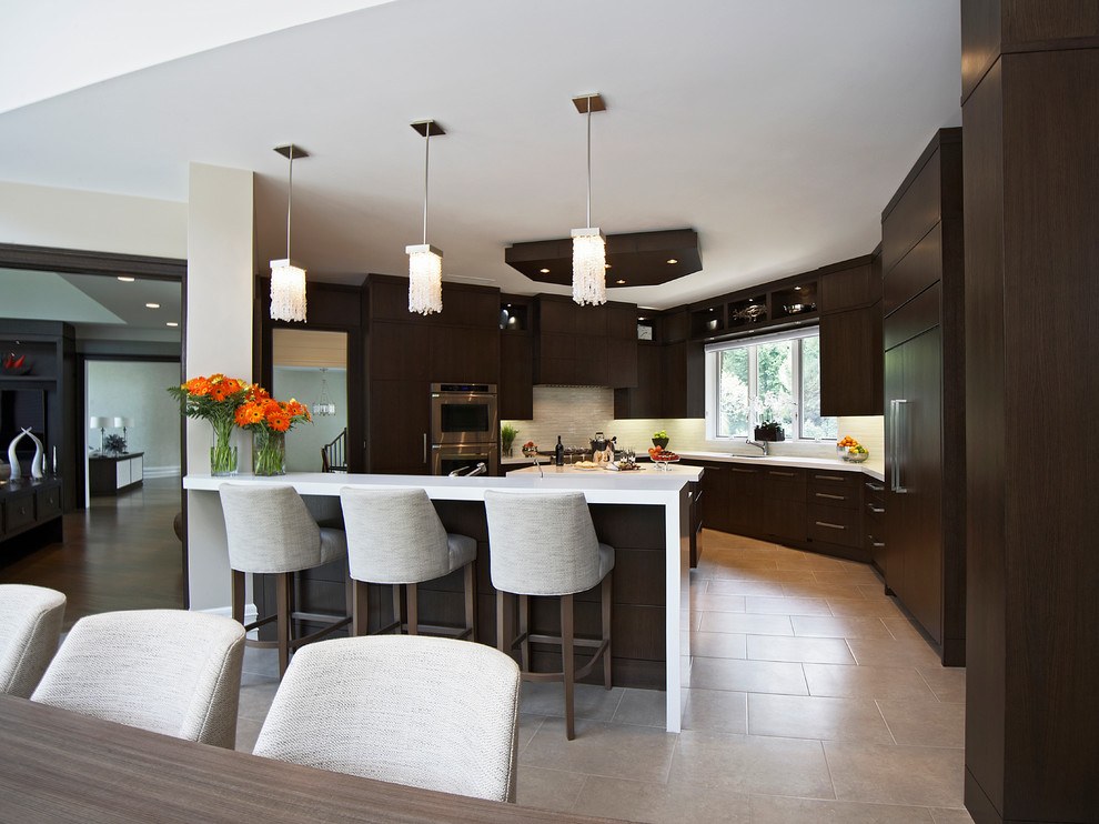 Enclosed kitchen - large transitional u-shaped porcelain tile enclosed kitchen idea in Toronto with an undermount sink, flat-panel cabinets, dark wood cabinets, quartz countertops, beige backsplash, stone tile backsplash, stainless steel appliances and an island