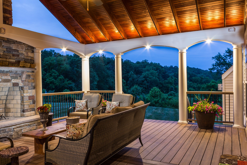 Large transitional backyard deck photo in Baltimore with a fire pit and a roof extension