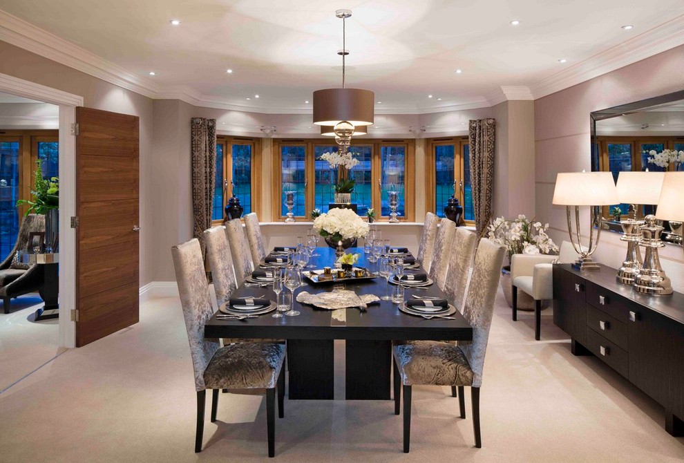 Inspiration for a transitional separate dining room in London with beige walls and carpet.