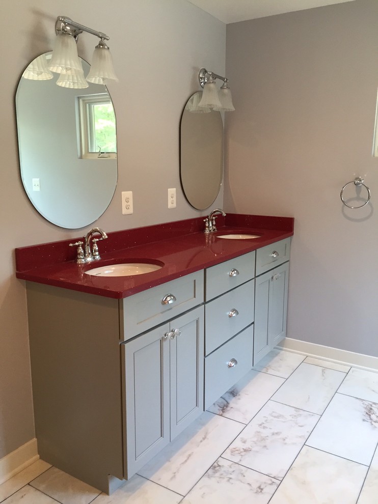 This is an example of a mid-sized contemporary master bathroom in DC Metro with recessed-panel cabinets, grey cabinets, grey walls, an undermount sink and red benchtops.
