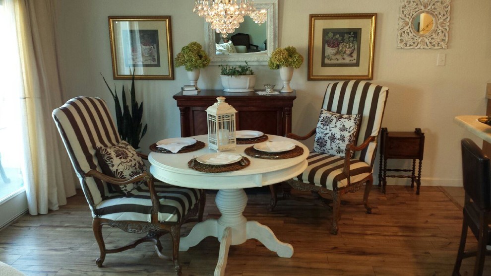 Transitional medium tone wood floor dining room photo with white walls