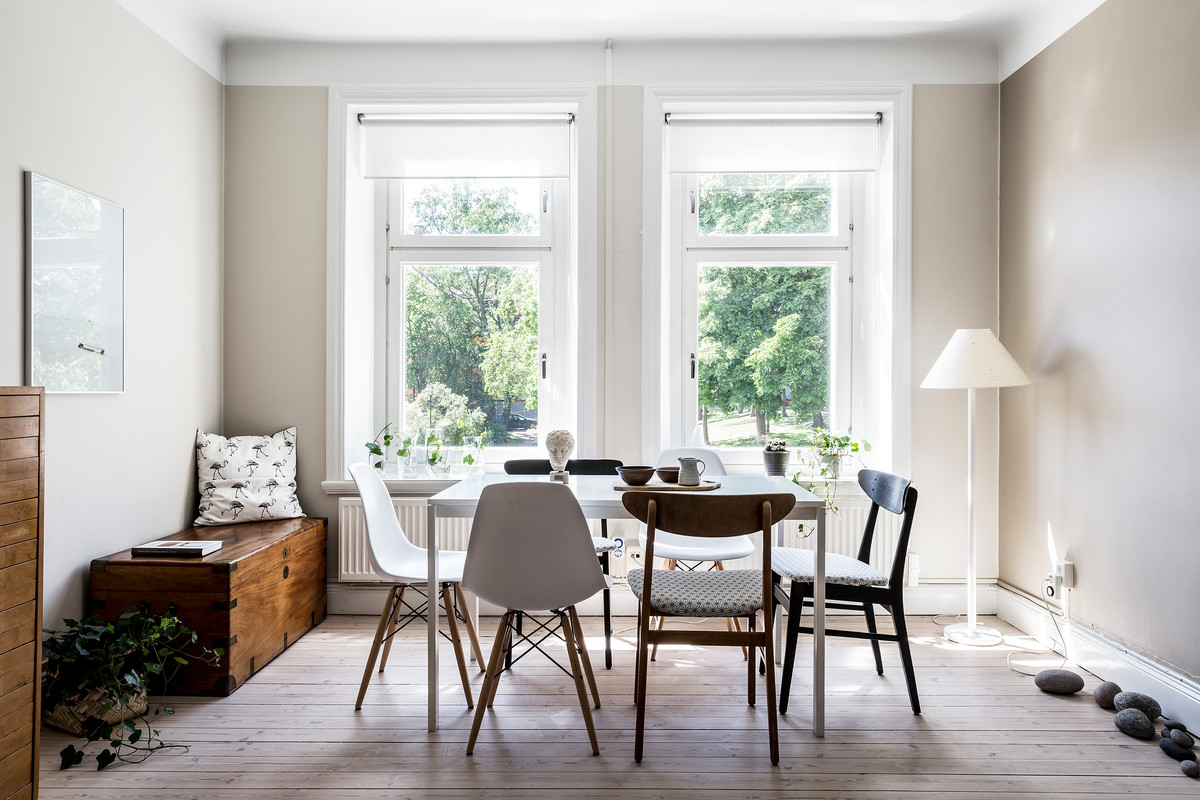 This is an example of a scandinavian dining room in Stockholm with beige walls, light hardwood floors and beige floor.