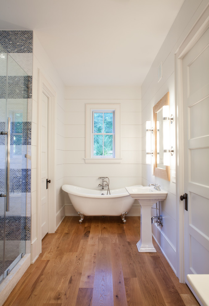 Inspiration for a country master bathroom in Other with a claw-foot tub, an alcove shower, beige tile, white walls and medium hardwood floors.