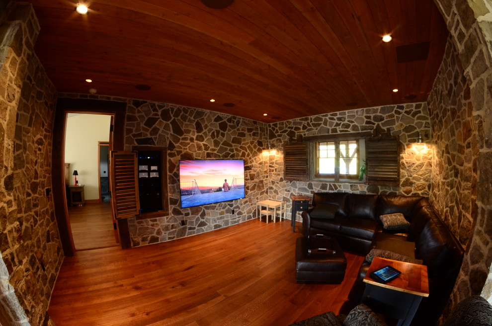 Photo of a mid-sized traditional enclosed living room in Denver with medium hardwood floors, a wall-mounted tv, multi-coloured walls and no fireplace.