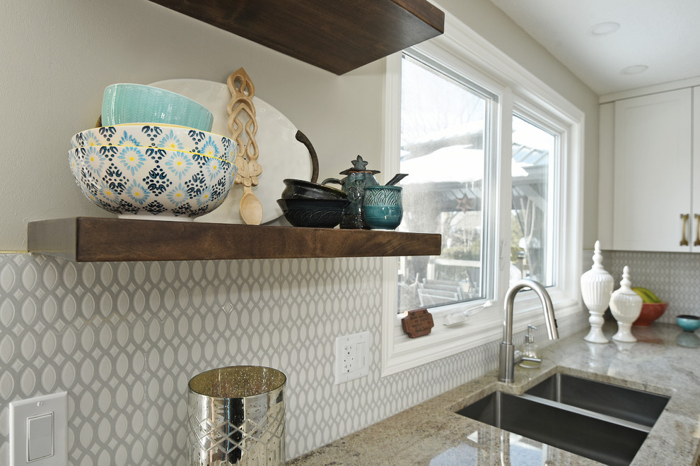 Inspiration for a mid-sized transitional cork floor enclosed kitchen remodel in Ottawa with an undermount sink, shaker cabinets, white cabinets, granite countertops, gray backsplash, ceramic backsplash, stainless steel appliances and an island