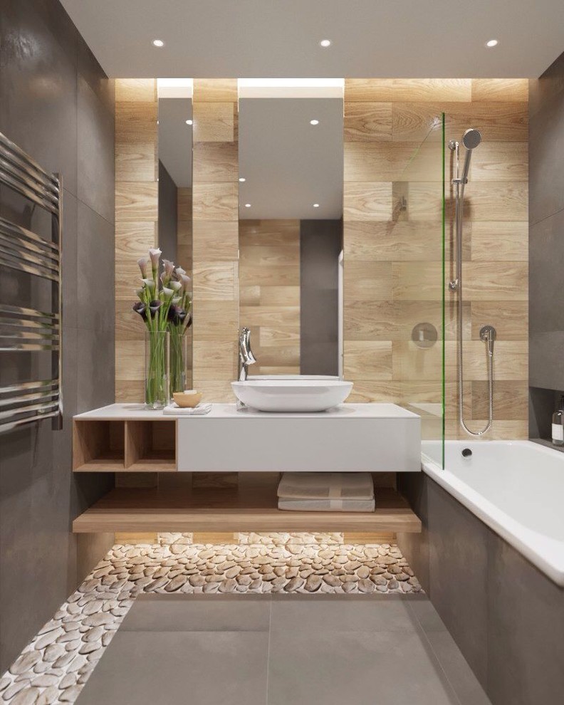 Design ideas for a contemporary master bathroom in San Francisco with white benchtops, open cabinets, white cabinets, a drop-in tub, a shower/bathtub combo, brown tile, cement tile, grey walls, pebble tile floors, a vessel sink, granite benchtops and grey floor.