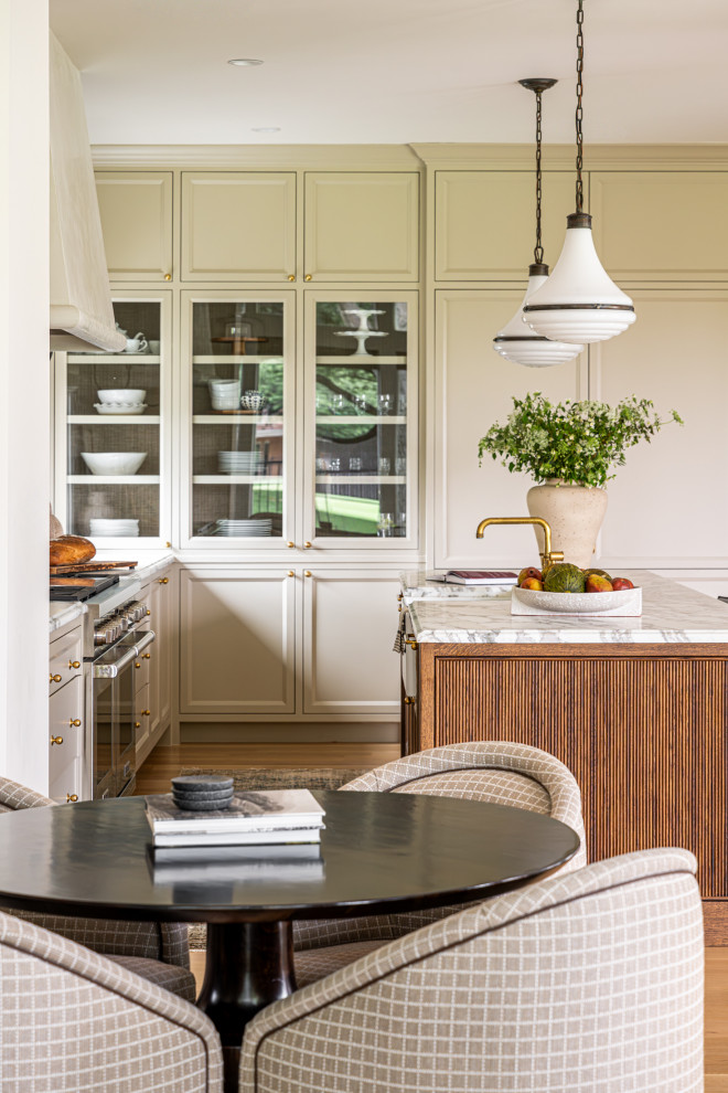 Large transitional light wood floor eat-in kitchen photo in Dallas with a farmhouse sink, recessed-panel cabinets, marble countertops, an island and white countertops
