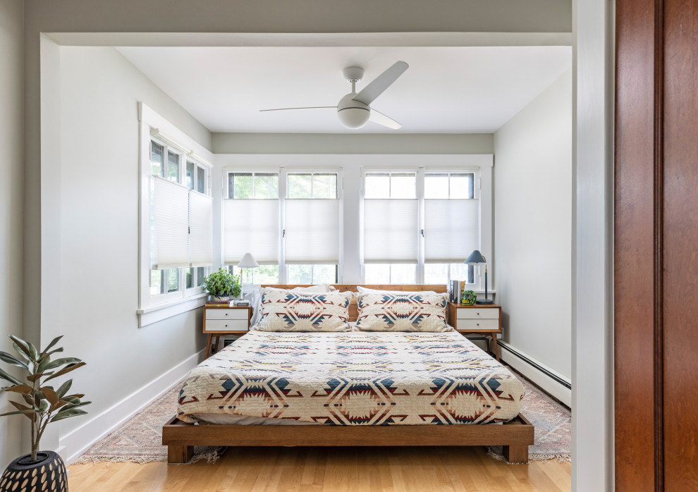 Inspiration for an eclectic master bedroom in Detroit with light hardwood floors.
