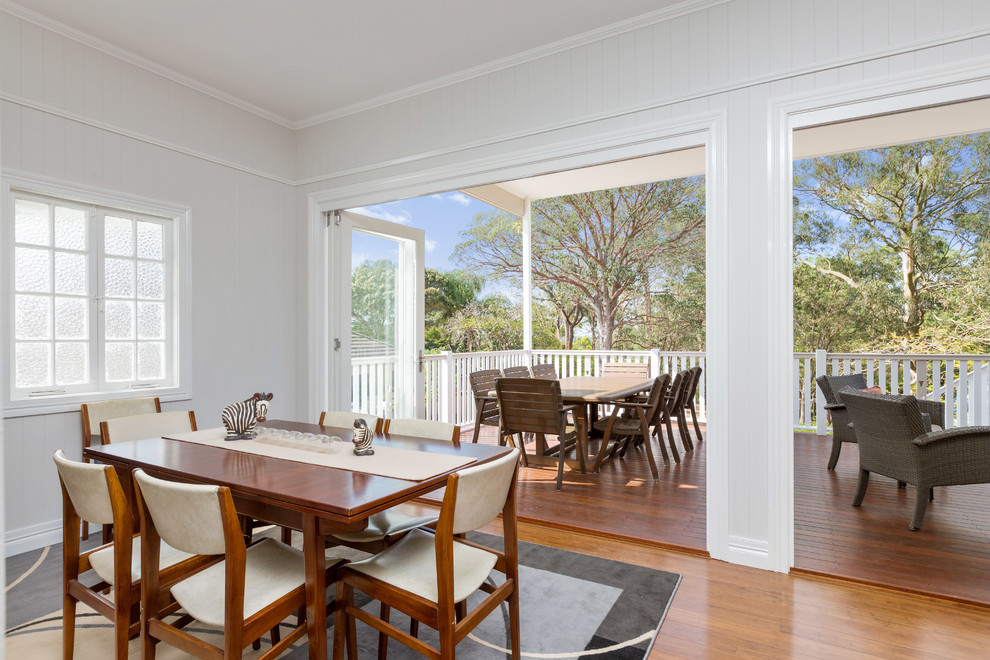 Mid-sized beach style separate dining room in Brisbane with beige walls and bamboo floors.