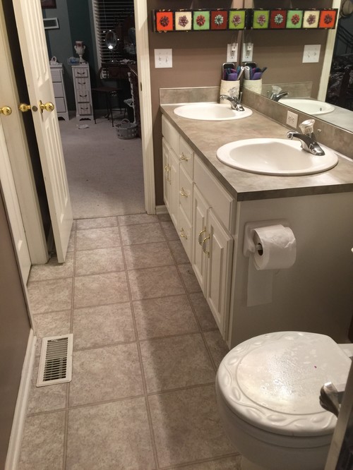 A small narrow  master bathroom 