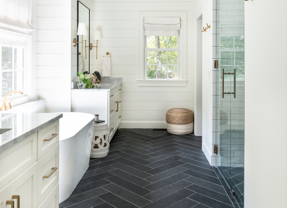 Design ideas for a large transitional master bathroom in Nashville with shaker cabinets, white cabinets, a freestanding tub, a curbless shower, a two-piece toilet, white tile, subway tile, white walls, slate floors, an undermount sink, marble benchtops, black floor, a hinged shower door, white benchtops, a niche, a single vanity, a built-in vanity, vaulted and planked wall panelling.