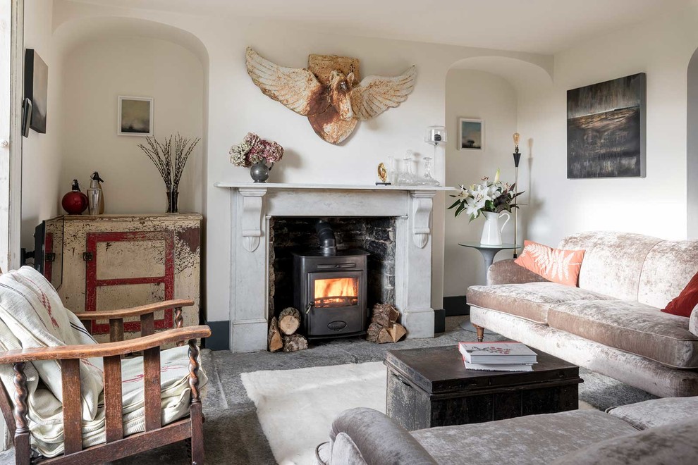 Country living room in Sussex with white walls and a wood stove.
