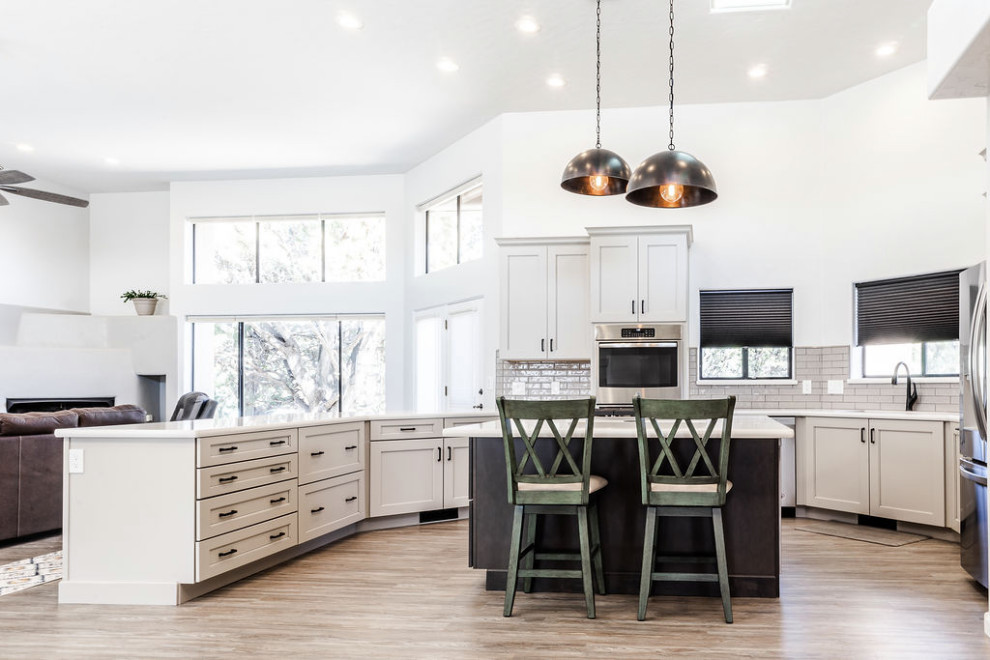Eat-in kitchen - large transitional u-shaped vinyl floor and gray floor eat-in kitchen idea with an undermount sink, shaker cabinets, gray cabinets, quartzite countertops, green backsplash, subway tile backsplash, stainless steel appliances, an island and white countertops