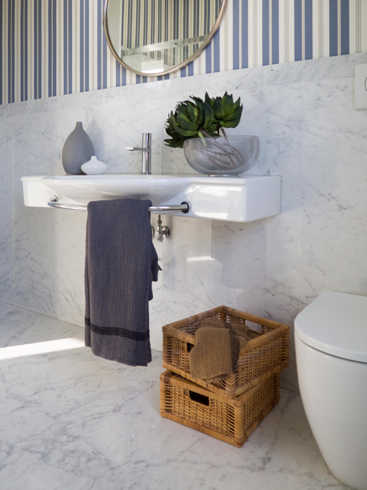 Large eclectic bathroom in Other with a corner shower, a two-piece toilet, white tiles, marble tiles, marble flooring, a wall-mounted sink, white floors, a single sink, a drop ceiling and wallpapered walls.