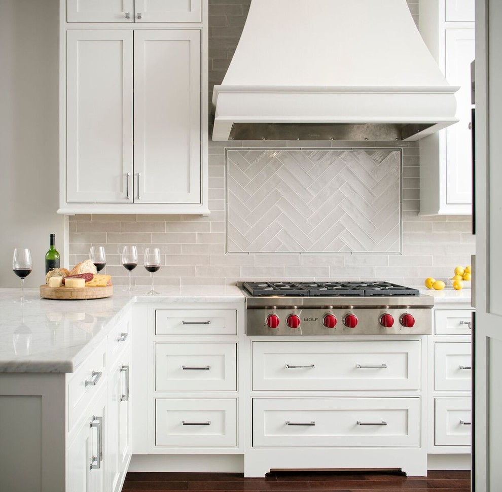 Inspiration for a small transitional l-shaped eat-in kitchen in DC Metro with an undermount sink, white cabinets, marble benchtops, grey splashback, glass tile splashback, stainless steel appliances, dark hardwood floors, a peninsula, shaker cabinets and brown floor.