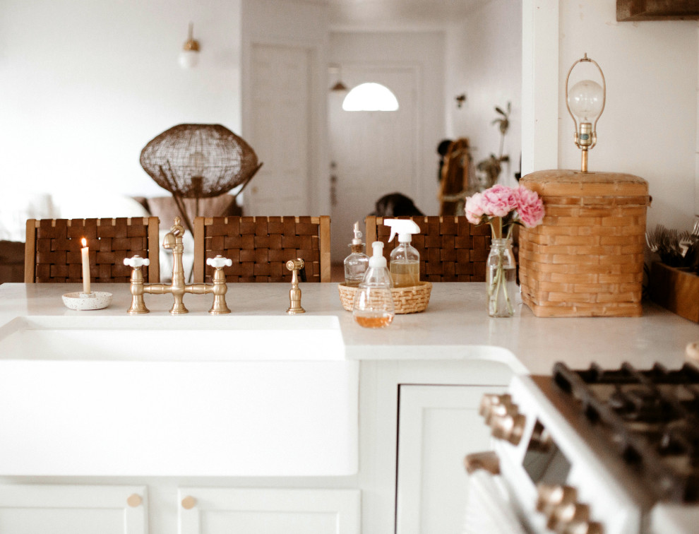 Open concept kitchen - eclectic l-shaped open concept kitchen idea in Los Angeles with recessed-panel cabinets, a farmhouse sink, white cabinets and white countertops
