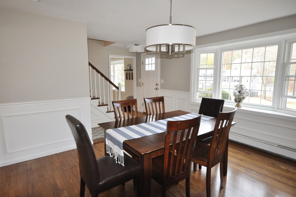 Photo of a transitional separate dining room in Boston with beige walls, medium hardwood floors, brown floor and decorative wall panelling.