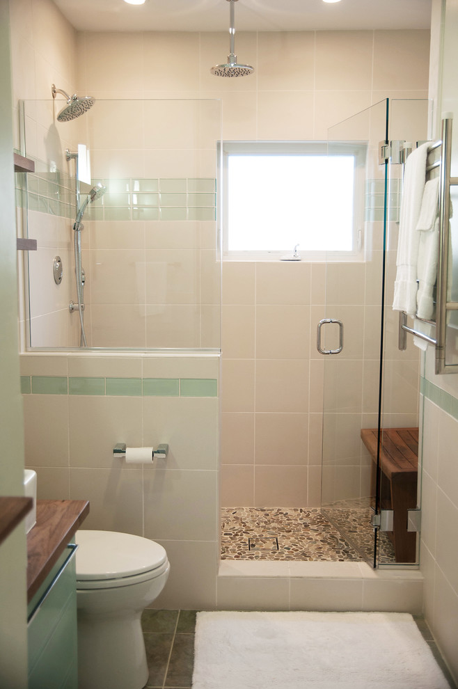 This is an example of a mid-sized midcentury 3/4 bathroom in Boston with a vessel sink, recessed-panel cabinets, blue cabinets, wood benchtops, an alcove shower, a one-piece toilet, multi-coloured tile, porcelain tile, green walls and porcelain floors.