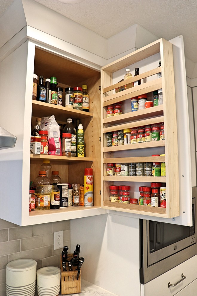 Kitchen pantry - transitional l-shaped medium tone wood floor and brown floor kitchen pantry idea in Cedar Rapids with an undermount sink, recessed-panel cabinets, white cabinets, quartzite countertops, gray backsplash, porcelain backsplash, stainless steel appliances, an island and white countertops