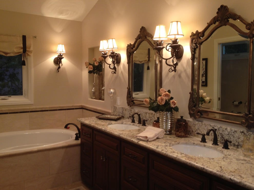 Design ideas for a large traditional master bathroom in Los Angeles with an undermount sink, raised-panel cabinets, dark wood cabinets, granite benchtops, an alcove tub, a corner shower, a two-piece toilet, beige tile, stone tile, beige walls and travertine floors.