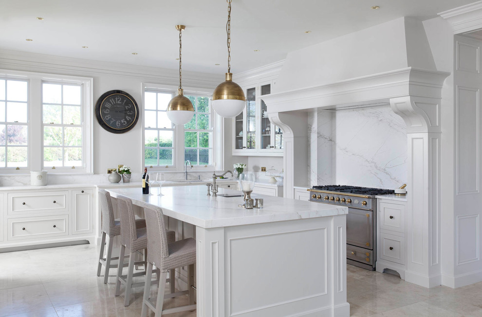 Photo of a large traditional u-shaped open plan kitchen in Other with a drop-in sink, beaded inset cabinets, white cabinets, marble benchtops, white splashback, marble splashback, stainless steel appliances, porcelain floors, with island, beige floor and yellow benchtop.