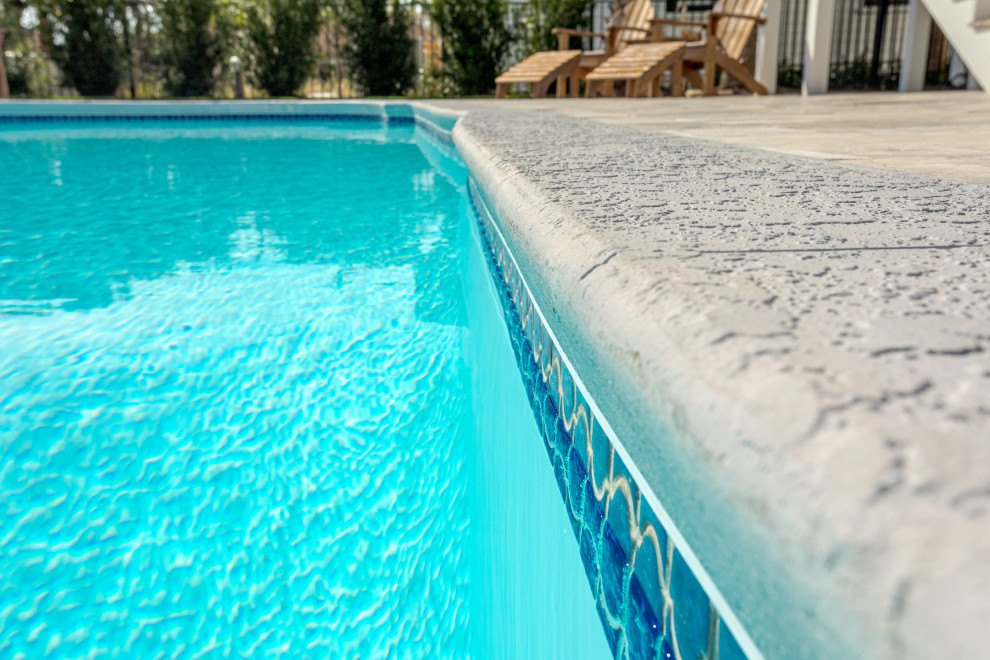 Idee per una piscina costiera di medie dimensioni e dietro casa con pavimentazioni in pietra naturale