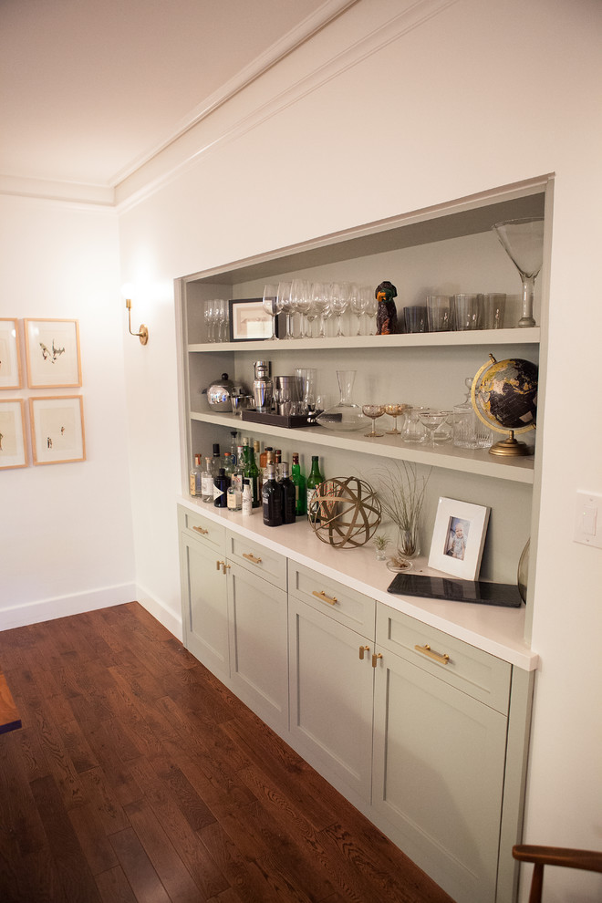 This is an example of a mid-sized contemporary galley home bar in San Francisco with shaker cabinets, beige cabinets and medium hardwood floors.