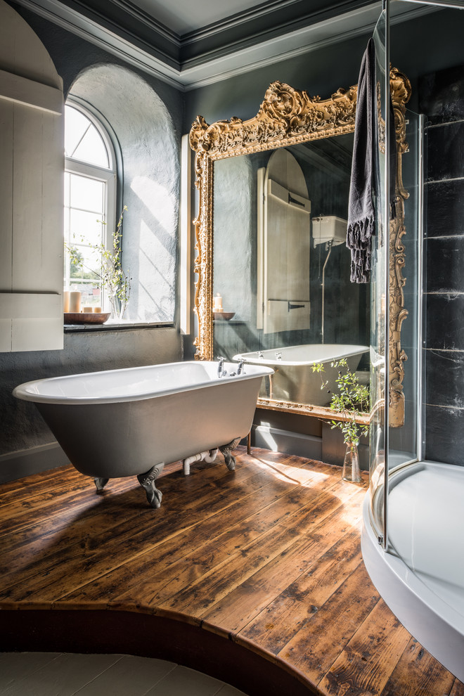 Large traditional master bathroom in Cornwall with a claw-foot tub, black tile, grey walls, dark hardwood floors and a corner shower.