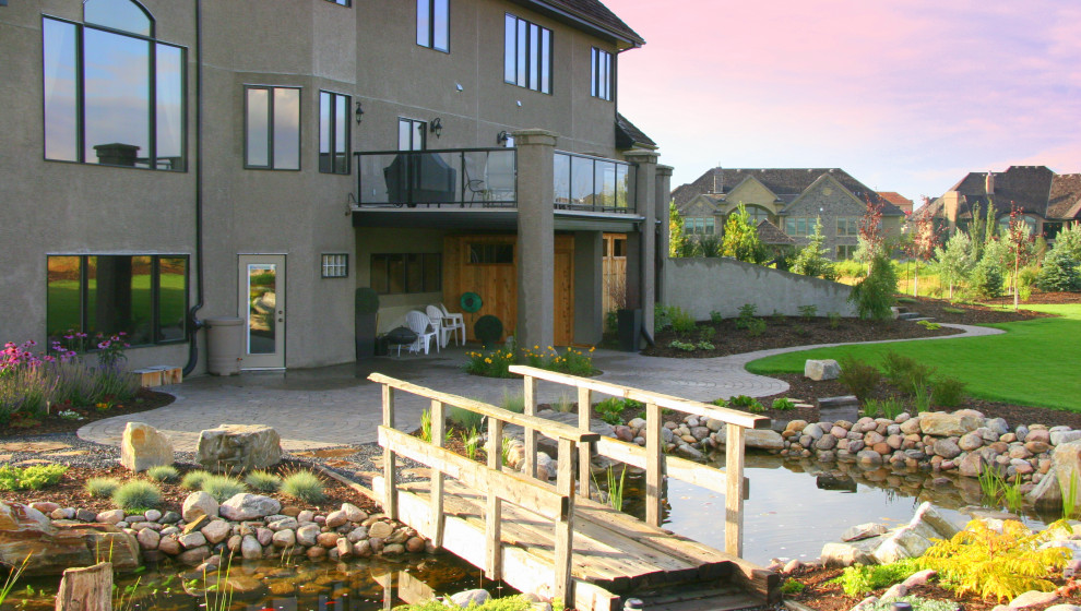 Design ideas for a huge rustic backyard landscaping in Edmonton.