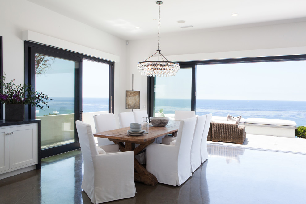 Design ideas for a contemporary open plan dining in Orange County with white walls and concrete floors.