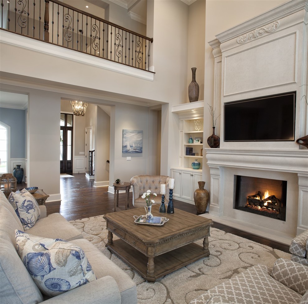 Small traditional open concept living room in Atlanta with beige walls, dark hardwood floors, a standard fireplace, a wood fireplace surround and a built-in media wall.