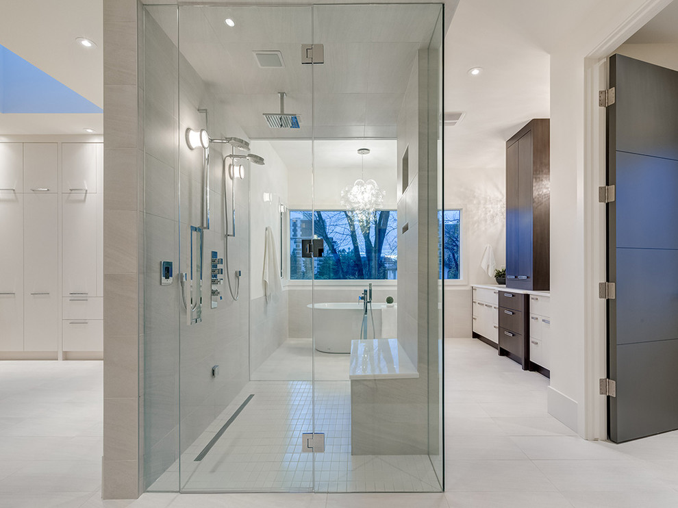 Expansive contemporary master bathroom in Calgary with flat-panel cabinets, white cabinets, a freestanding tub, a curbless shower and white walls.