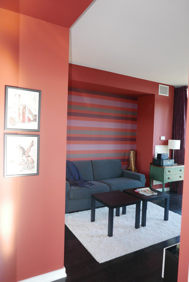 Design ideas for a mid-sized transitional study room in Toronto with red walls, dark hardwood floors, no fireplace, a freestanding desk and black floor.