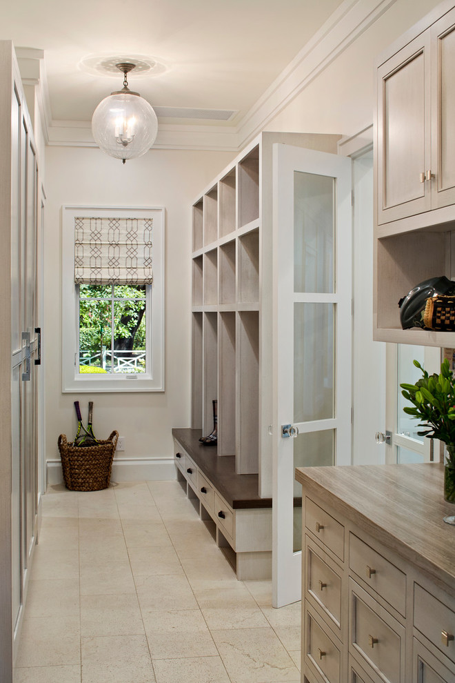This is an example of a transitional mudroom in San Francisco with granite floors and white walls.