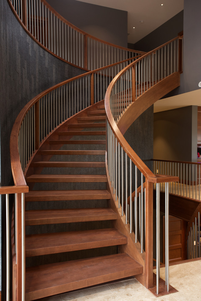 Inspiration for an arts and crafts wood curved staircase in Edmonton with open risers and wood railing.