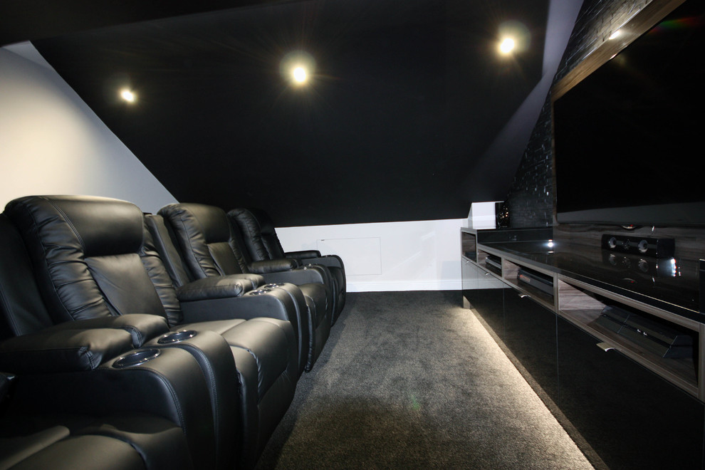 Photo of an expansive contemporary open concept home theatre in Kent with grey walls, carpet and grey floor.