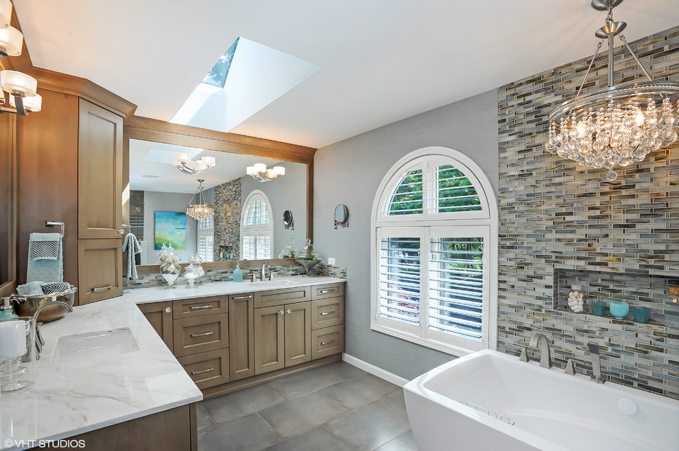 Inspiration for a mid-sized transitional master multicolored tile and mosaic tile ceramic tile freestanding bathtub remodel in Seattle with an undermount sink, shaker cabinets, medium tone wood cabinets, marble countertops, a bidet and gray walls