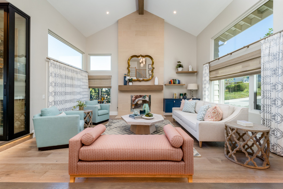 Mid-sized beach style open concept living room in Orange County with grey walls, light hardwood floors, a stone fireplace surround, beige floor and vaulted.