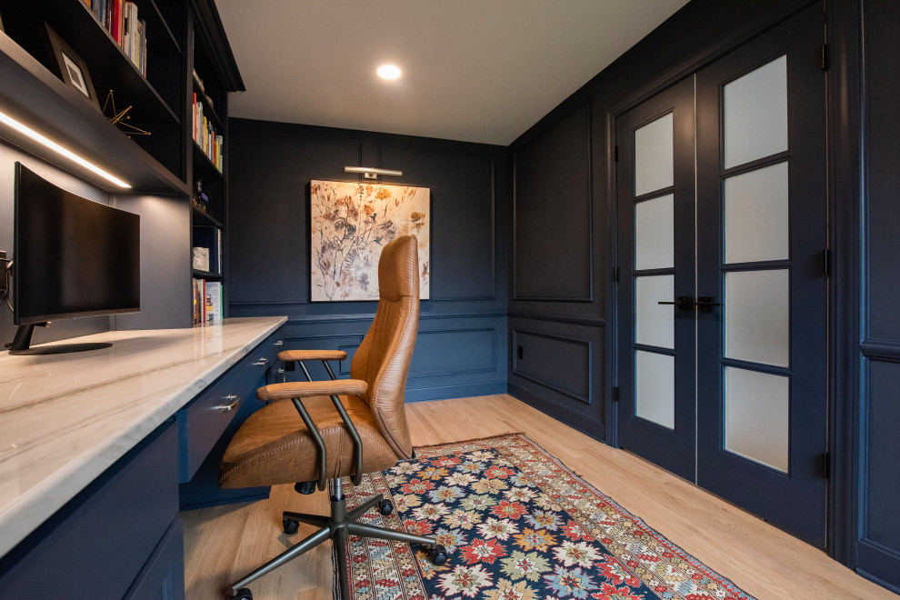 Mid-sized modern study room in Louisville with blue walls, light hardwood floors, a built-in desk and decorative wall panelling.