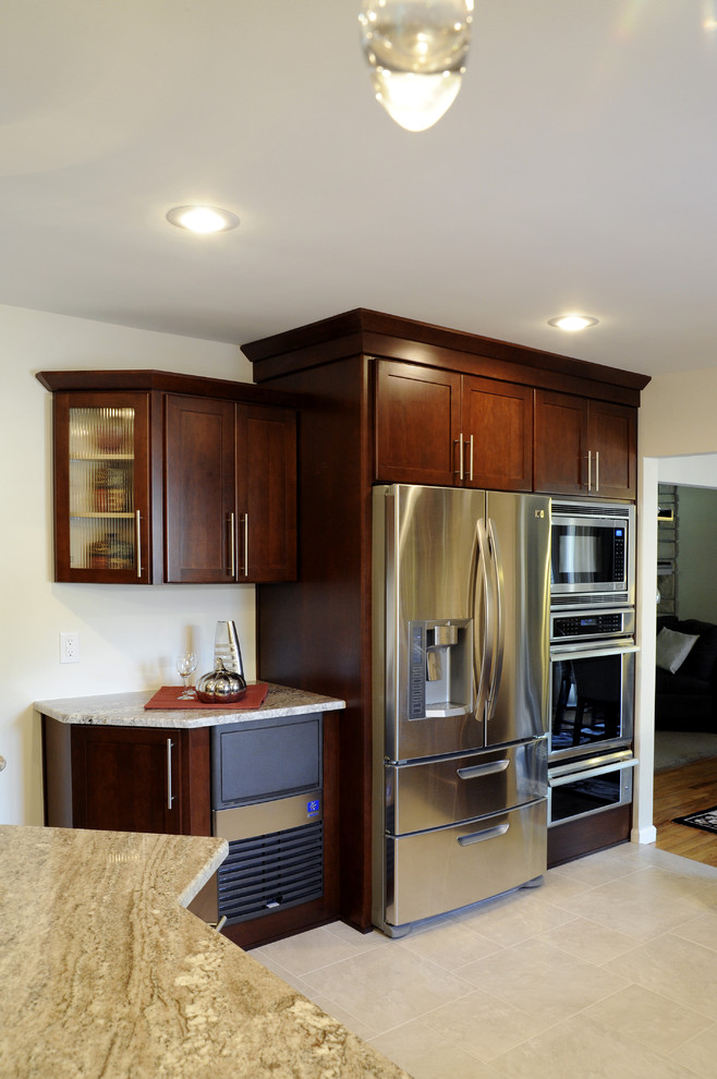 Eat-in kitchen - large transitional u-shaped ceramic tile and beige floor eat-in kitchen idea with a double-bowl sink, shaker cabinets, dark wood cabinets, granite countertops, beige backsplash, mosaic tile backsplash, stainless steel appliances and a peninsula
