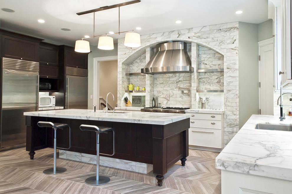 Eat-in kitchen - large contemporary u-shaped limestone floor eat-in kitchen idea in New York with an undermount sink, recessed-panel cabinets, dark wood cabinets, marble countertops, white backsplash, stone tile backsplash, stainless steel appliances and an island