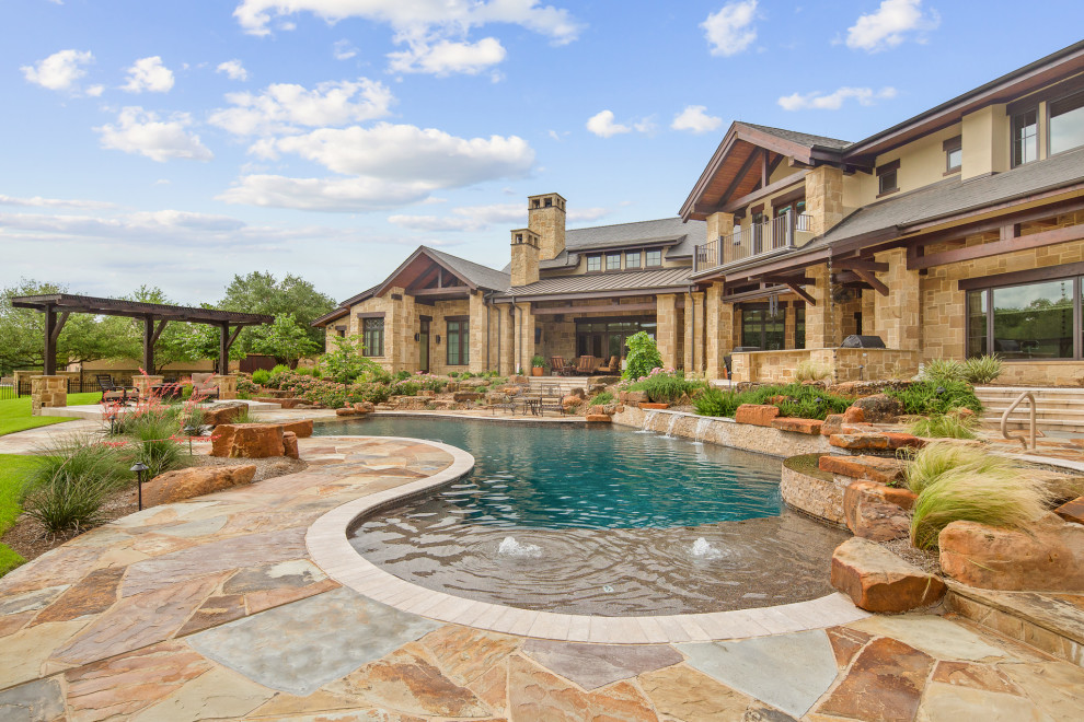 Custom-shaped pool in Houston with natural stone pavers.