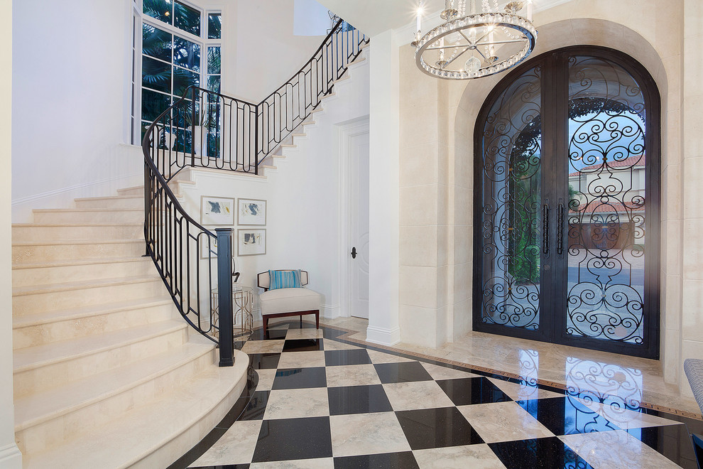 Photo of a traditional foyer in Miami with a double front door and a glass front door.